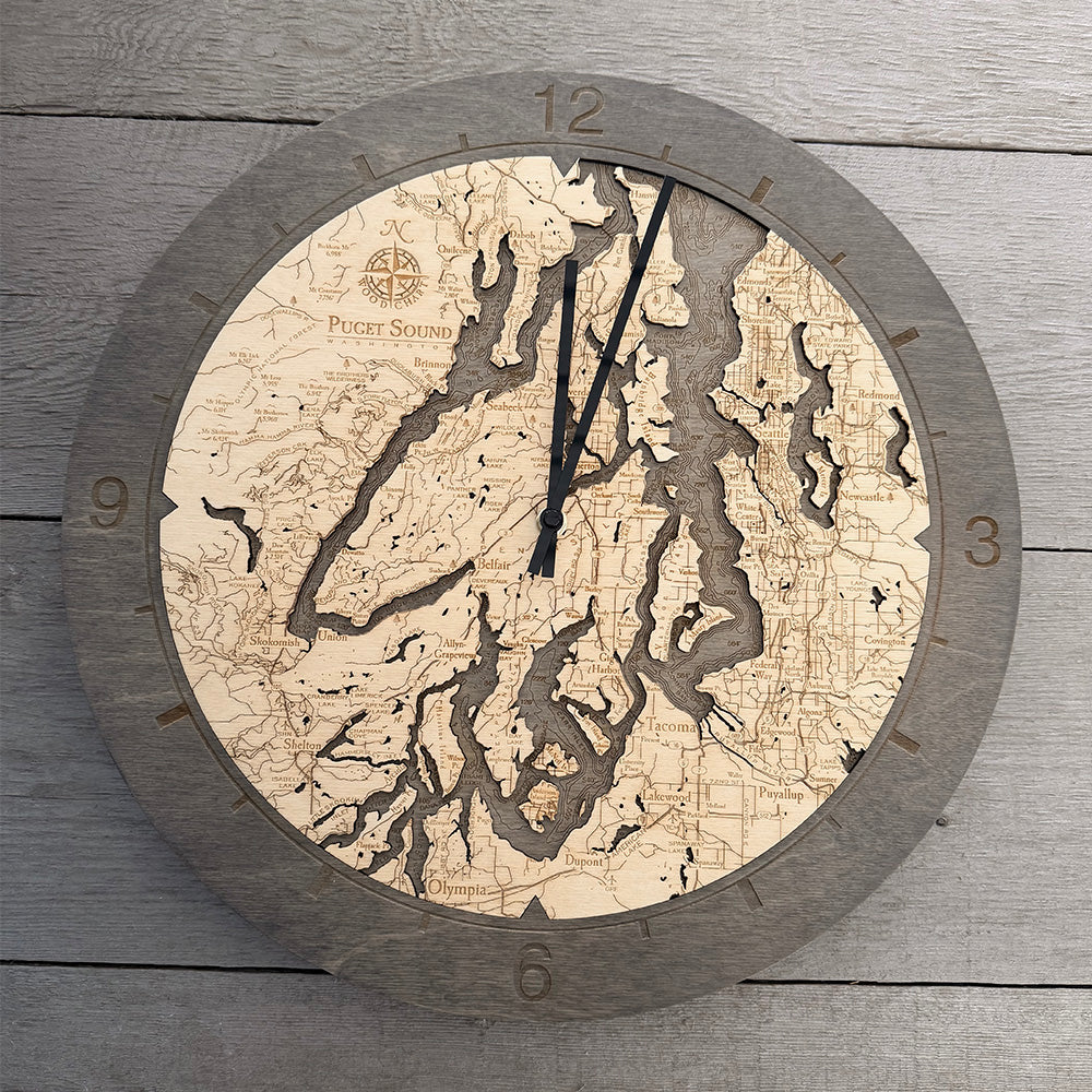 Puget Sound, Washington wood wall clock in laser-cut Baltic birch, shown framed against a light wall