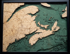 Canadian Maritimes 3D layered wood map in laser-cut Baltic birch, shown framed against a light wall