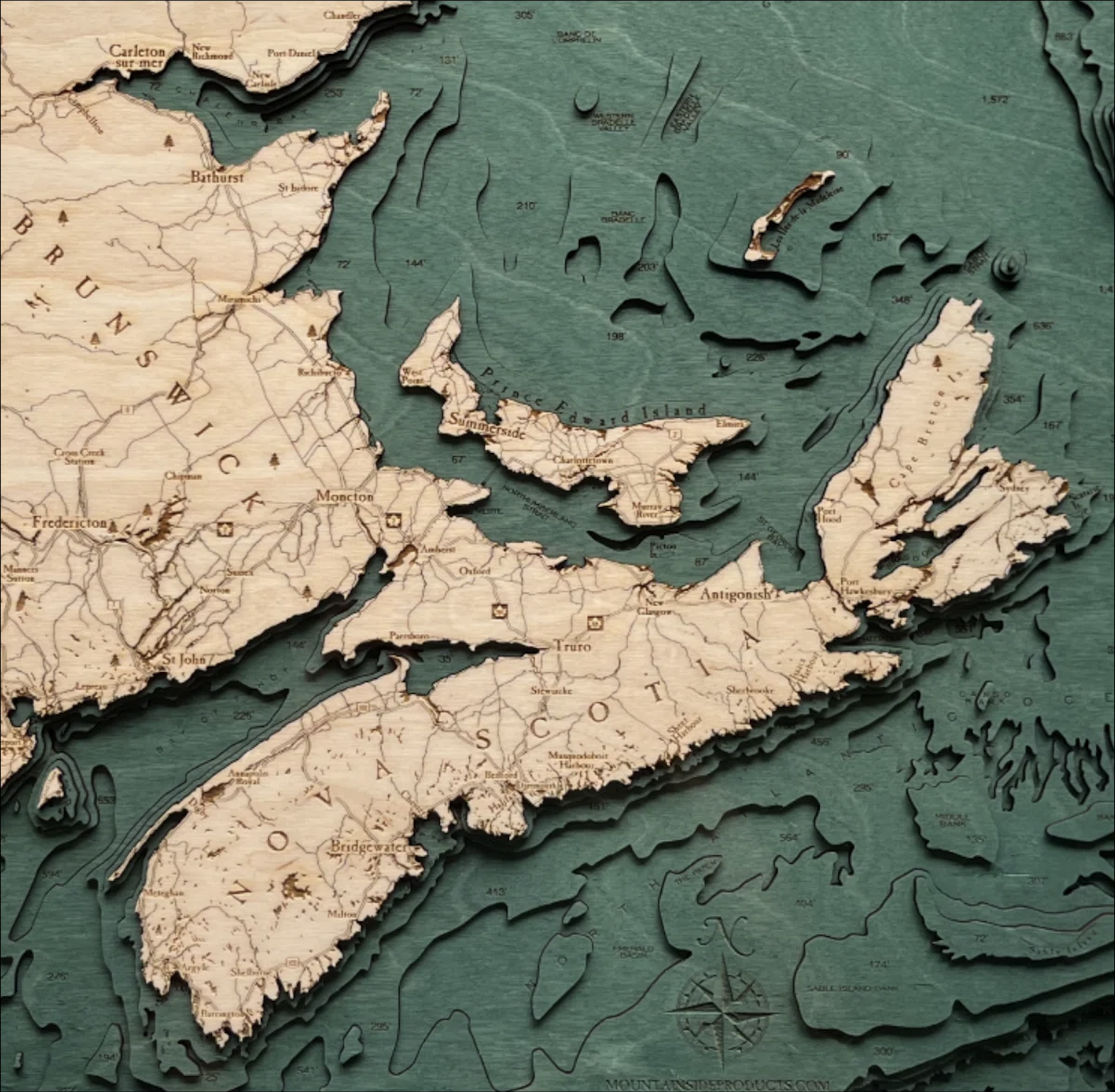 Canadian Maritimes 3D layered wood map in laser-cut Baltic birch, shown framed against a light wall