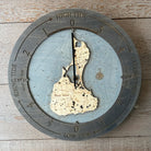 Block Island, Rhode Island wood tide clock in laser-cut Baltic birch, shown framed against a light wall