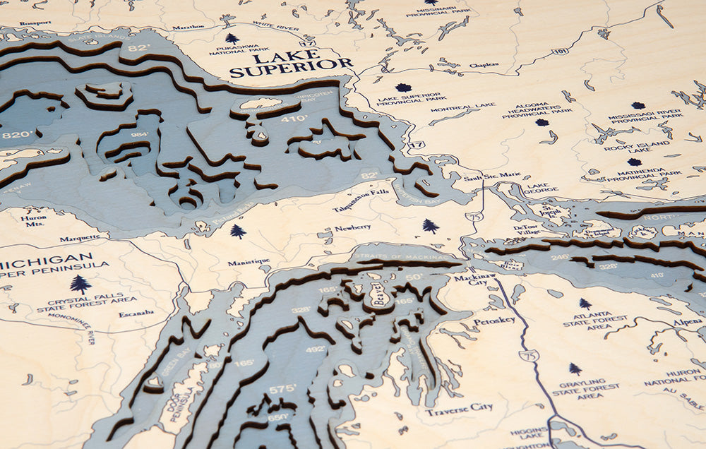 Great Lakes, Michigan 3D layered wood map in laser-cut Baltic birch, shown framed against a light wall