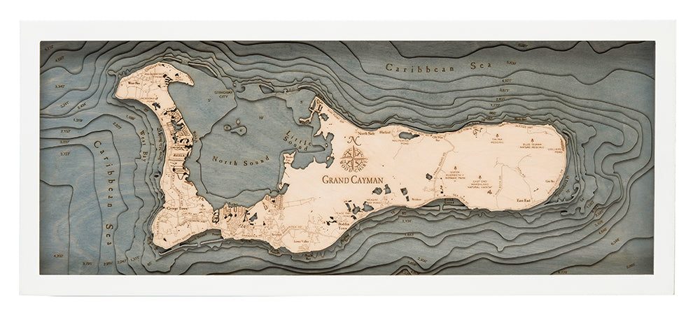 Grand Cayman, Caribbean 3D layered wood map in laser-cut Baltic birch, shown framed against a light wall