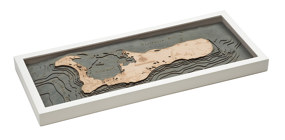 Grand Cayman, Caribbean 3D layered wood map in laser-cut Baltic birch, shown framed against a light wall