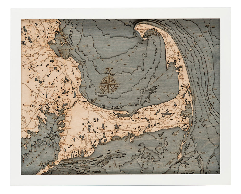 Cape Cod, Massachusetts 3D layered wood map in laser-cut Baltic birch, shown framed against a light wall
