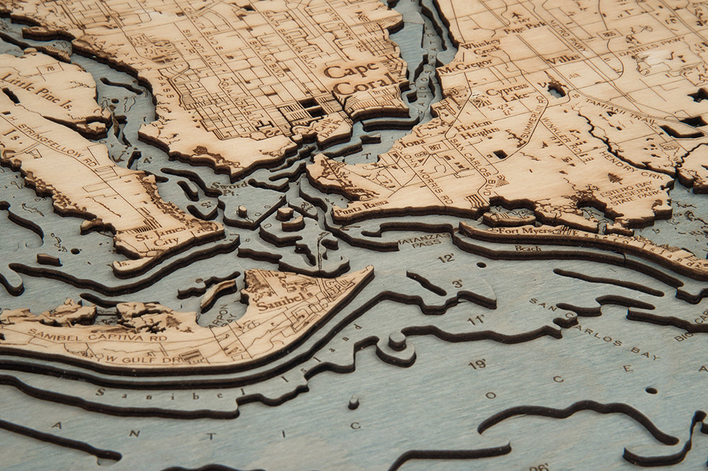 Fort Myers, Florida 3D layered wood map in laser-cut Baltic birch, shown framed against a light wall