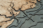 Georgia Coast 3D layered wood map in laser-cut Baltic birch, shown framed against a light wall