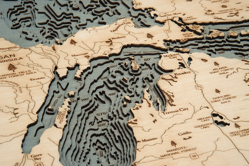 Great Lakes 3D layered wood map in laser-cut Baltic birch, shown framed against a light wall