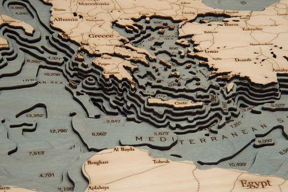 Mediterranean Sea 3D layered wood map in laser-cut Baltic birch, shown framed against a light wall