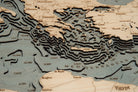 Mediterranean Sea 3D layered wood map in laser-cut Baltic birch, shown framed against a light wall