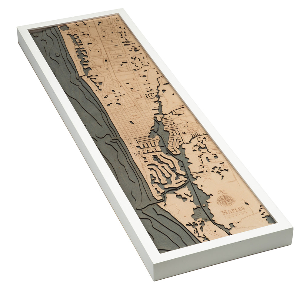 Naples, Florida 3D layered wood map in laser-cut Baltic birch, shown framed against a light wall