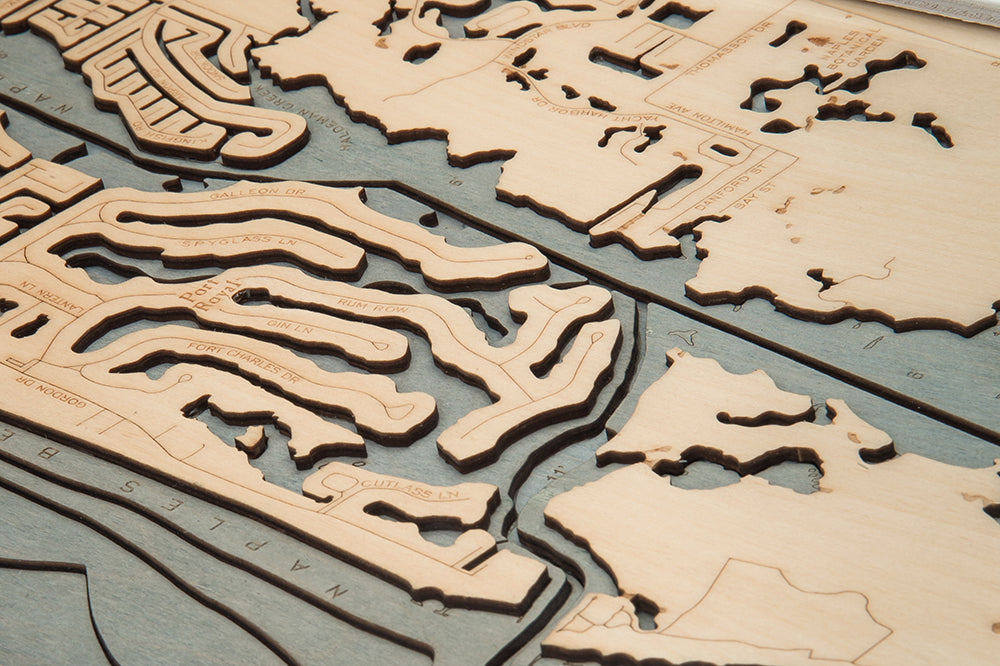 Naples, Florida 3D layered wood map in laser-cut Baltic birch, shown framed against a light wall