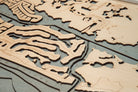 Naples, Florida 3D layered wood map in laser-cut Baltic birch, shown framed against a light wall