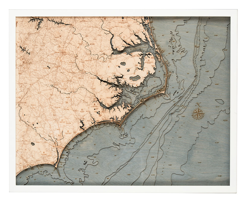 North Carolina Coast 3D layered wood map in laser-cut Baltic birch, shown framed against a light wall
