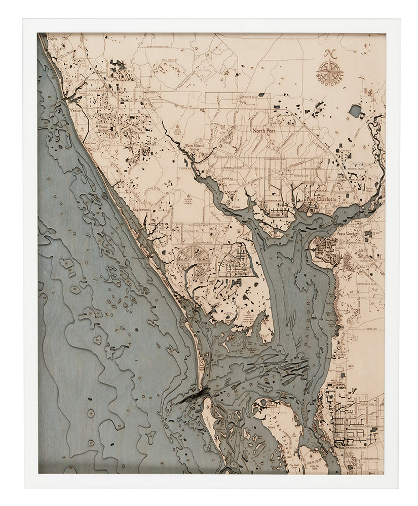 Charlotte Harbor, Florida 3D layered wood map in laser-cut Baltic birch, shown framed against a light wall