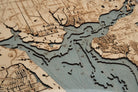 Charlotte Harbor, Florida 3D layered wood map in laser-cut Baltic birch, shown framed against a light wall