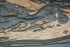 Sanibel Island, Florida 3D layered wood map in laser-cut Baltic birch, shown framed against a light wall