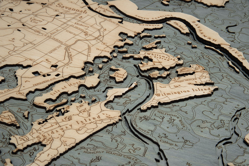 Savannah, Georgia 3D layered wood map in laser-cut Baltic birch, shown framed against a light wall