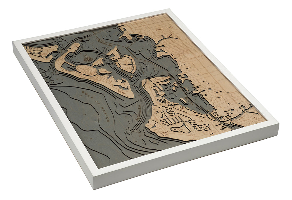 Siesta Key, Florida 3D layered wood map in laser-cut Baltic birch, shown framed against a light wall