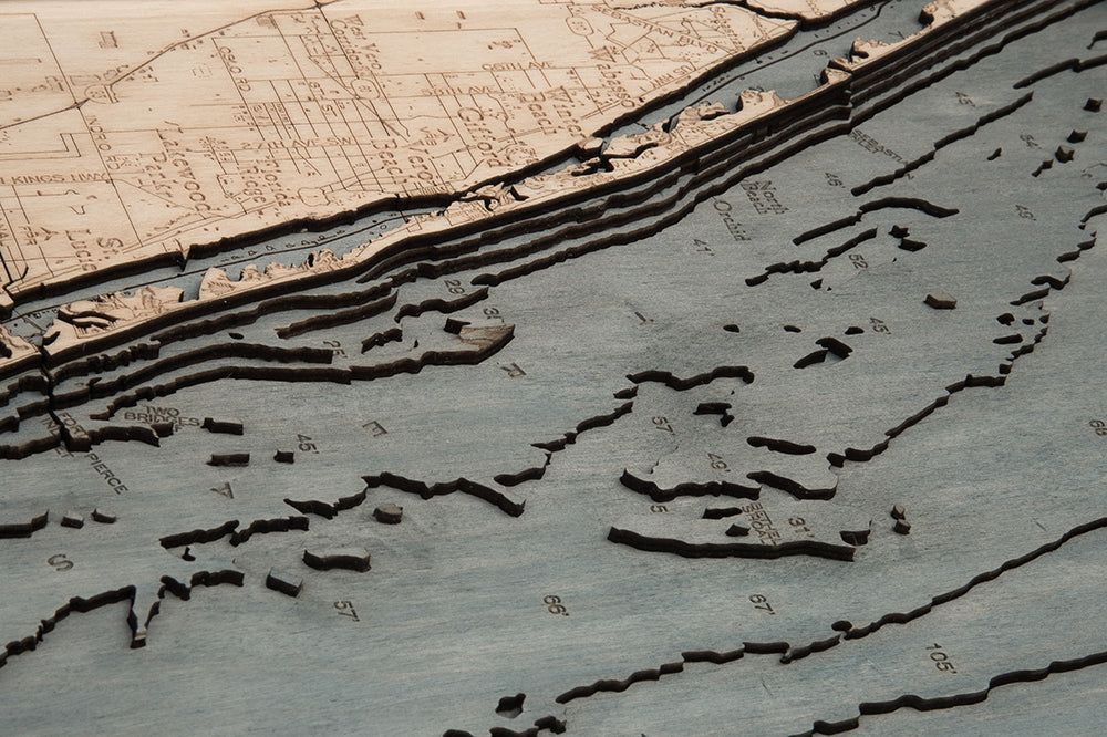 Treasure Coast, Florida 3D layered wood map in laser-cut Baltic birch, shown framed against a light wall