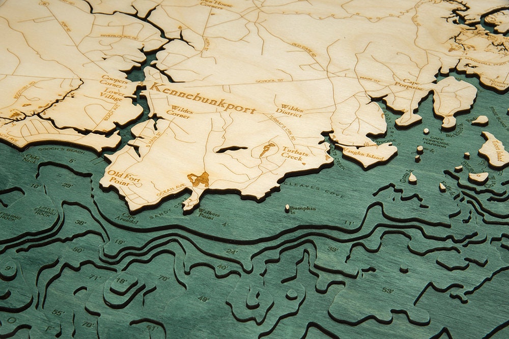 Kennebunkport, Maine 3D layered wood map in laser-cut Baltic birch, shown framed against a light wall