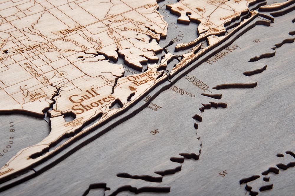 Western Panhandle, Florida 3D layered wood map in laser-cut Baltic birch, shown framed against a light wall