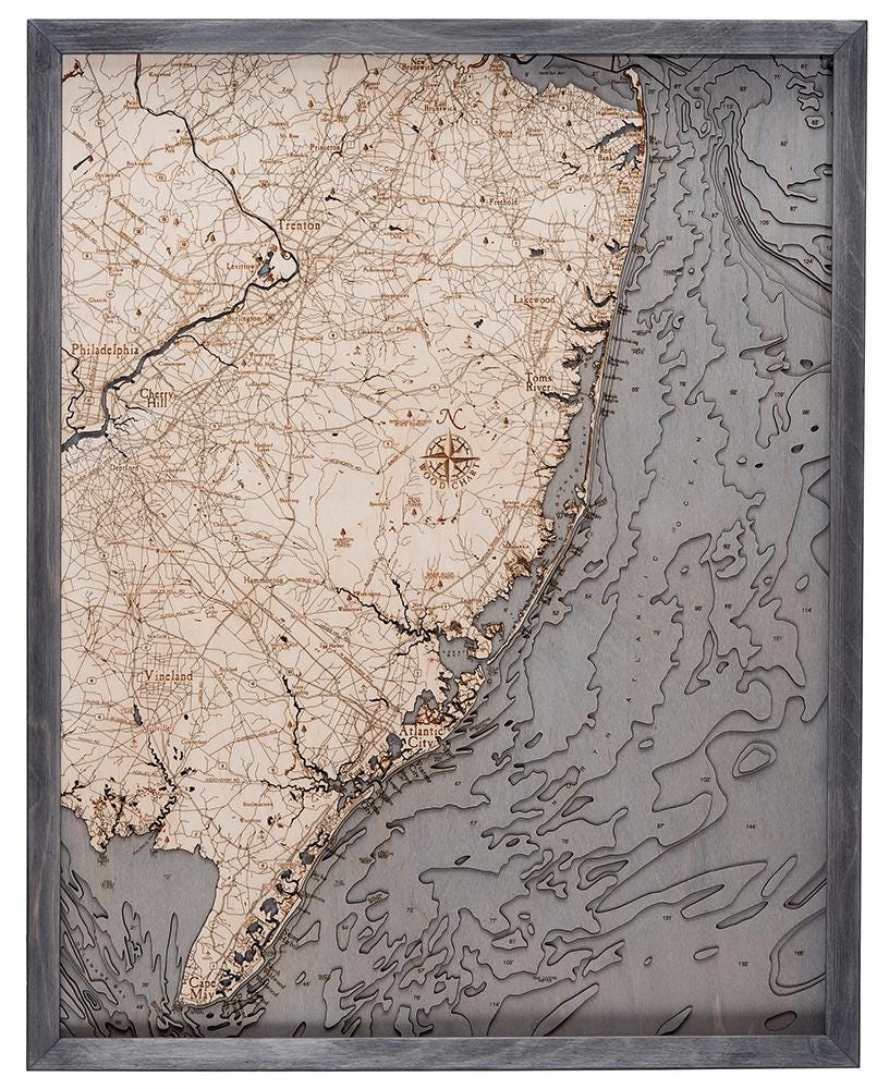 New Jersey Coast 3D layered wood map in laser-cut Baltic birch, shown framed against a light wall