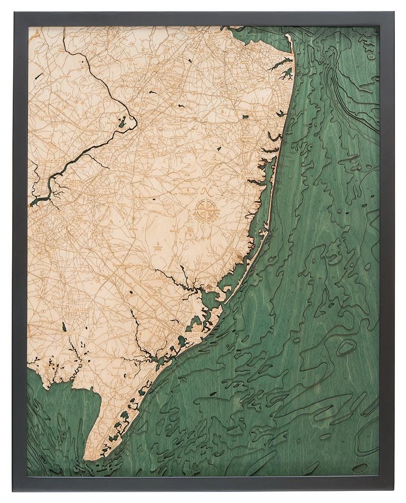 New Jersey Coast 3D layered wood map in laser-cut Baltic birch, shown framed against a light wall