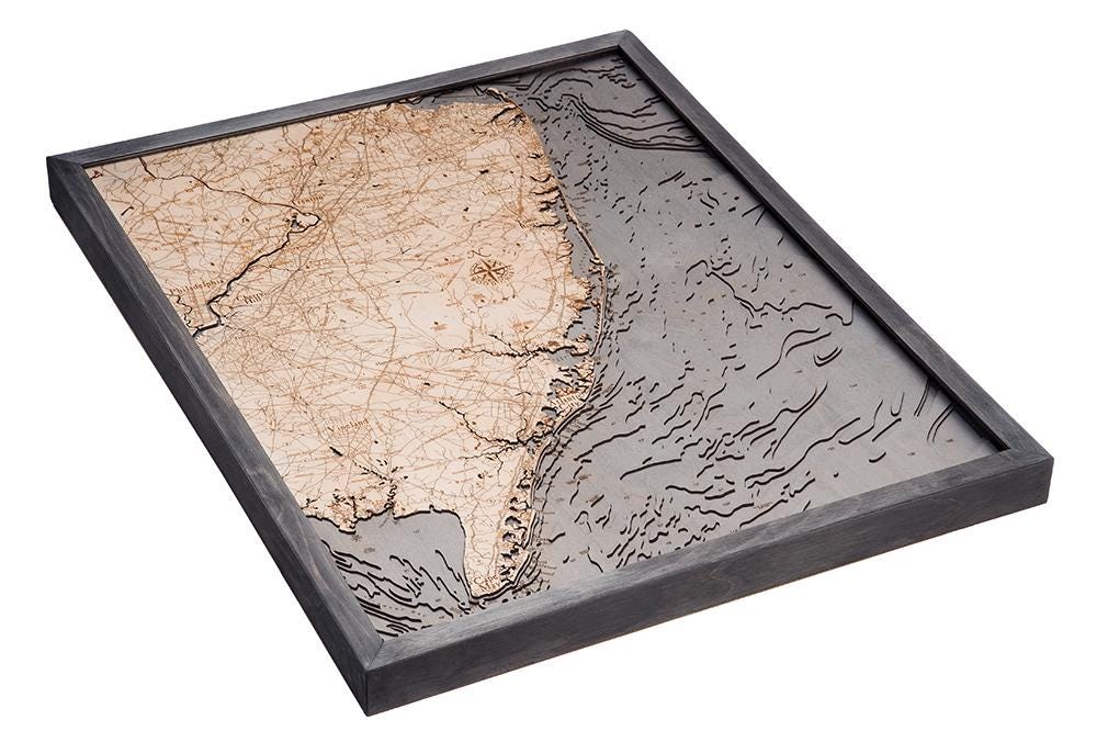 New Jersey Coast 3D layered wood map in laser-cut Baltic birch, shown framed against a light wall