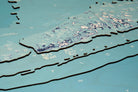 Florida Keys 3D layered wood map in laser-cut Baltic birch, shown framed against a light wall
