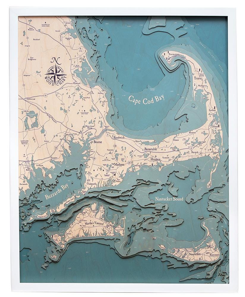 Cape Cod, Massachusetts 3D layered wood map in laser-cut Baltic birch, shown framed against a light wall