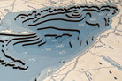 Lake Erie 3D layered wood map in laser-cut Baltic birch, shown framed against a light wall