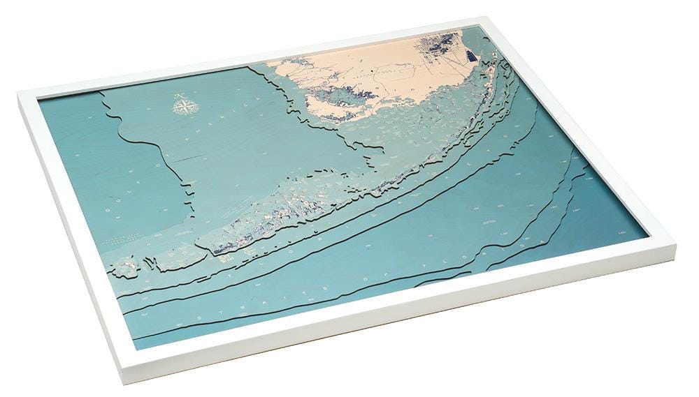 Florida Keys 3D layered wood map in laser-cut Baltic birch, shown framed against a light wall