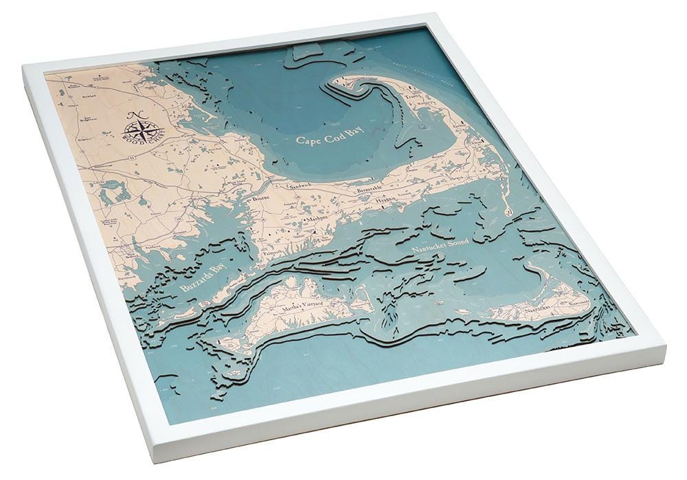 Cape Cod, Massachusetts 3D layered wood map in laser-cut Baltic birch, shown framed against a light wall