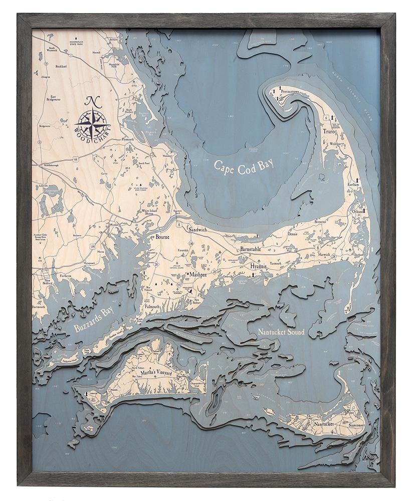 Cape Cod, Massachusetts 3D layered wood map in laser-cut Baltic birch, shown framed against a light wall