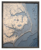 Outer Banks, North Carolina 3D layered wood map in laser-cut Baltic birch, shown framed against a light wall