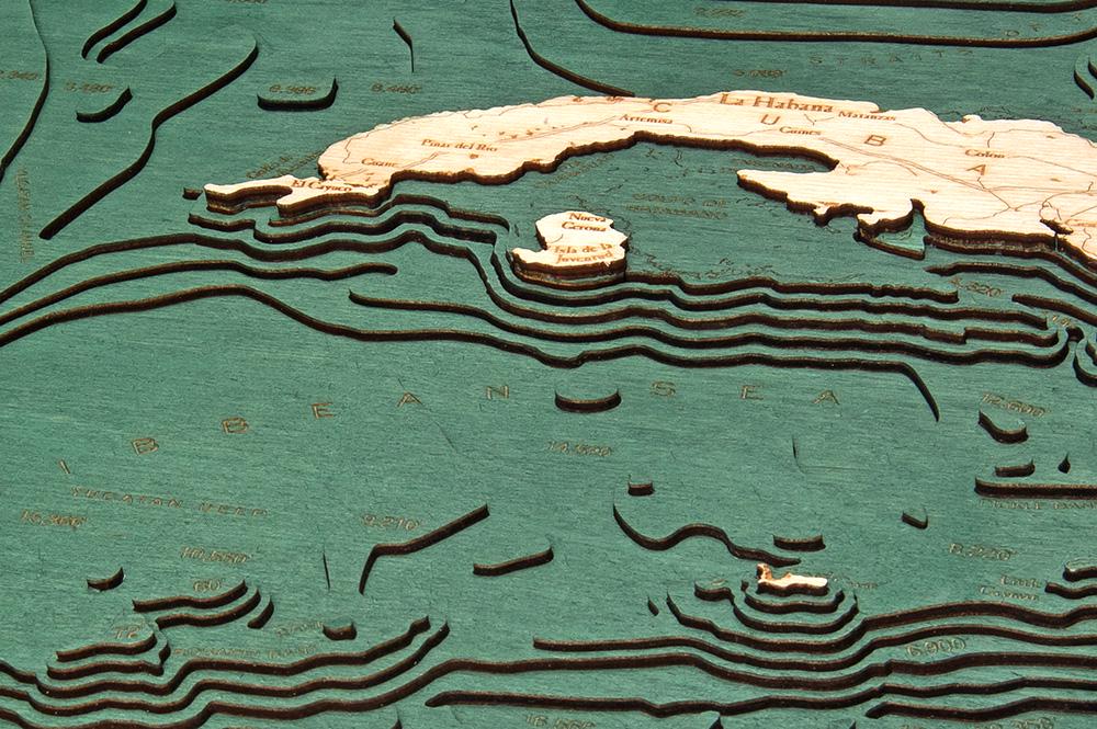 Gulf Of America 3D layered wood map in laser-cut Baltic birch, shown framed against a light wall