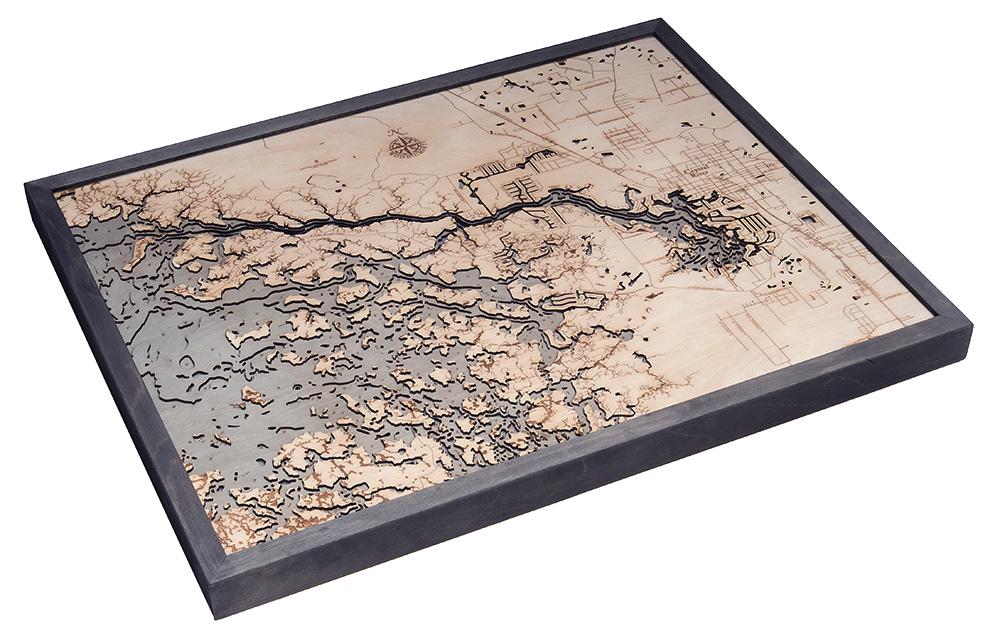 Crystal River, Florida 3D layered wood map in laser-cut Baltic birch, shown framed against a light wall