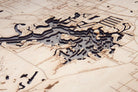 Crystal River, Florida 3D layered wood map in laser-cut Baltic birch, shown framed against a light wall