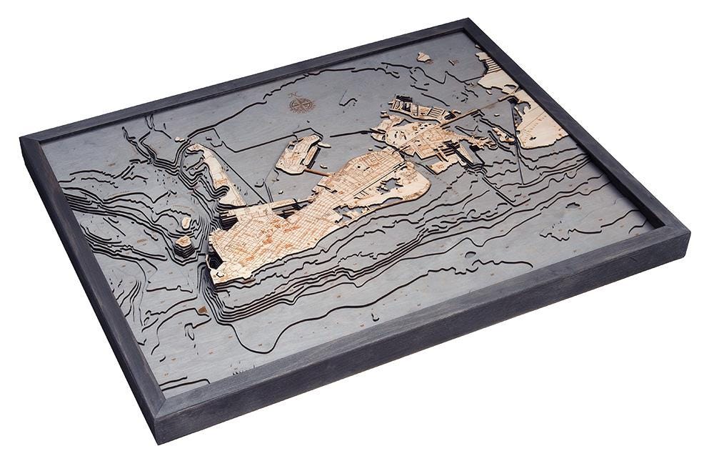 Key West, Florida 3D layered wood map in laser-cut Baltic birch, shown framed against a light wall