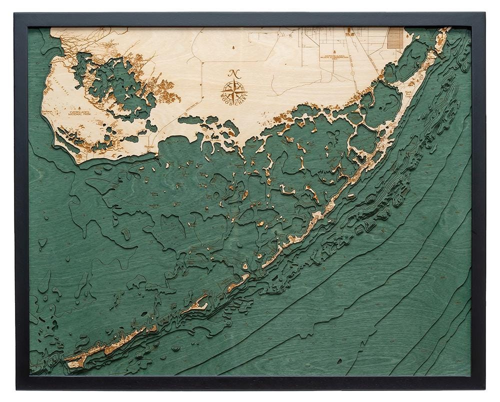 Upper Florida Keys 3D layered wood map in laser-cut Baltic birch, shown framed against a light wall