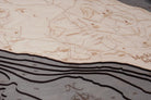 Mackinac Island, Michigan 3D layered wood map in laser-cut Baltic birch, shown framed against a light wall