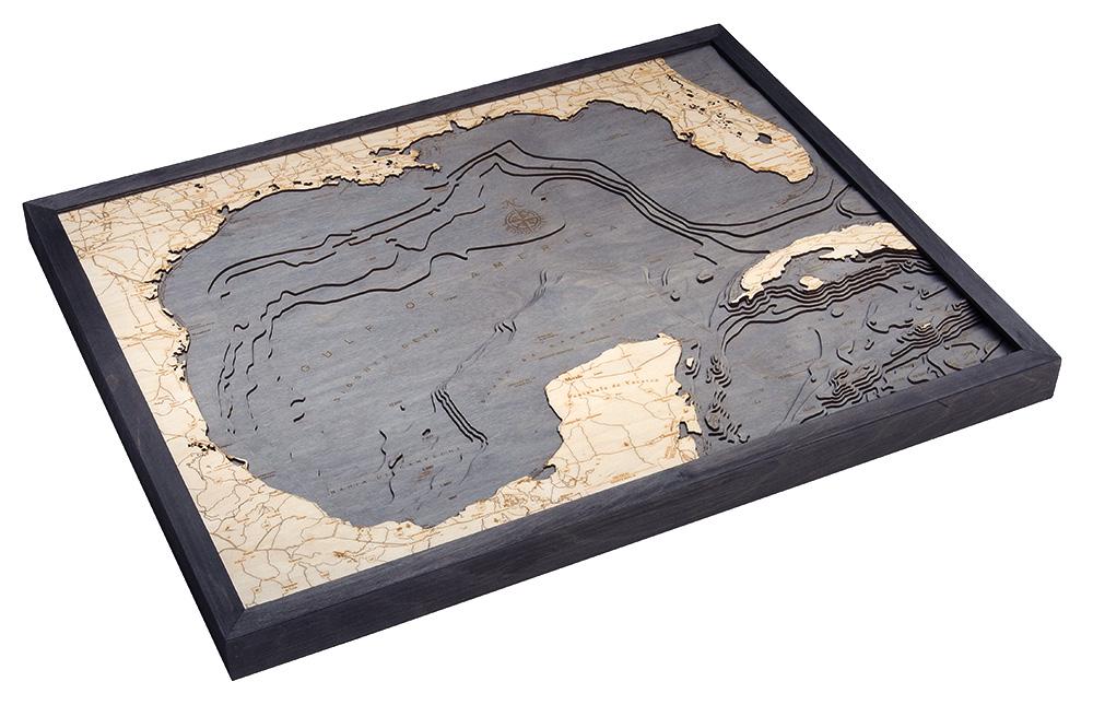 Gulf Of America 3D layered wood map in laser-cut Baltic birch, shown framed against a light wall