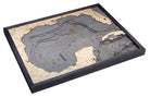 Gulf Of America 3D layered wood map in laser-cut Baltic birch, shown framed against a light wall