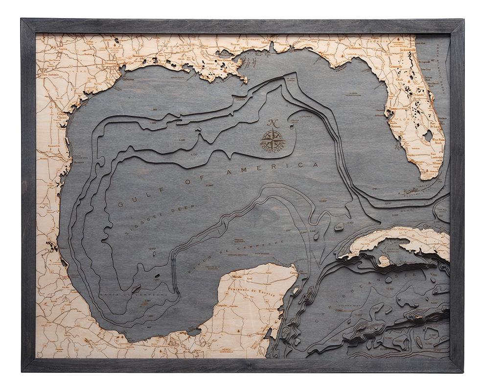 Gulf Of America 3D layered wood map in laser-cut Baltic birch, shown framed against a light wall