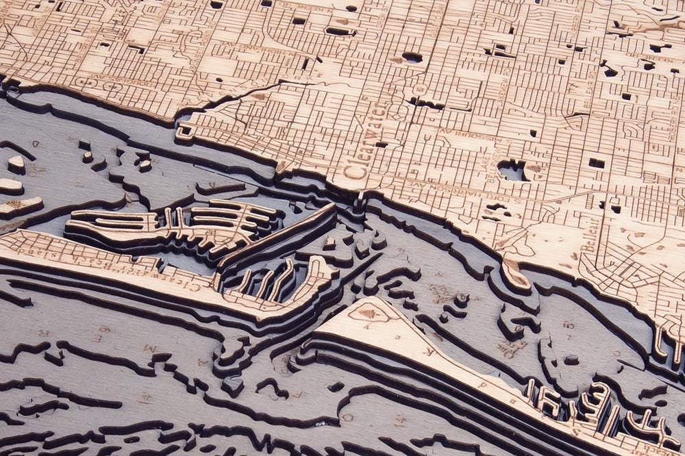 Anclote Key to Indian Shores, Florida 3D layered wood map in laser-cut Baltic birch, shown framed against a light wall