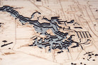 Crystal River, Florida 3D layered wood map in laser-cut Baltic birch, shown framed against a light wall