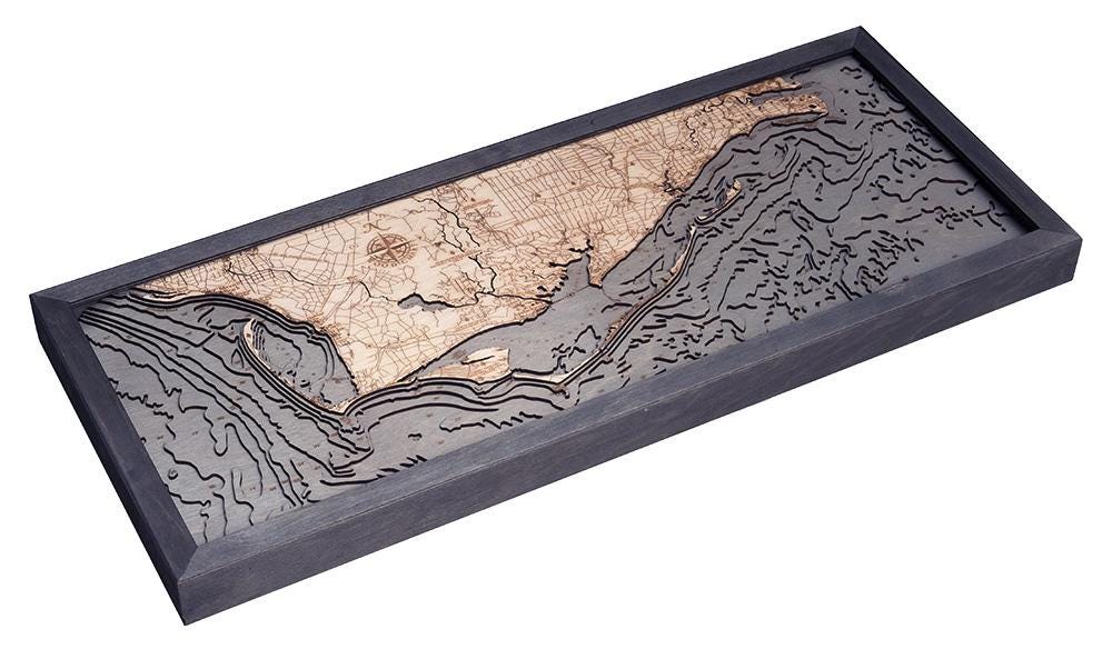 Mexico Beach to Bald Point, Florida 3D layered wood map in laser-cut Baltic birch, shown framed against a light wall