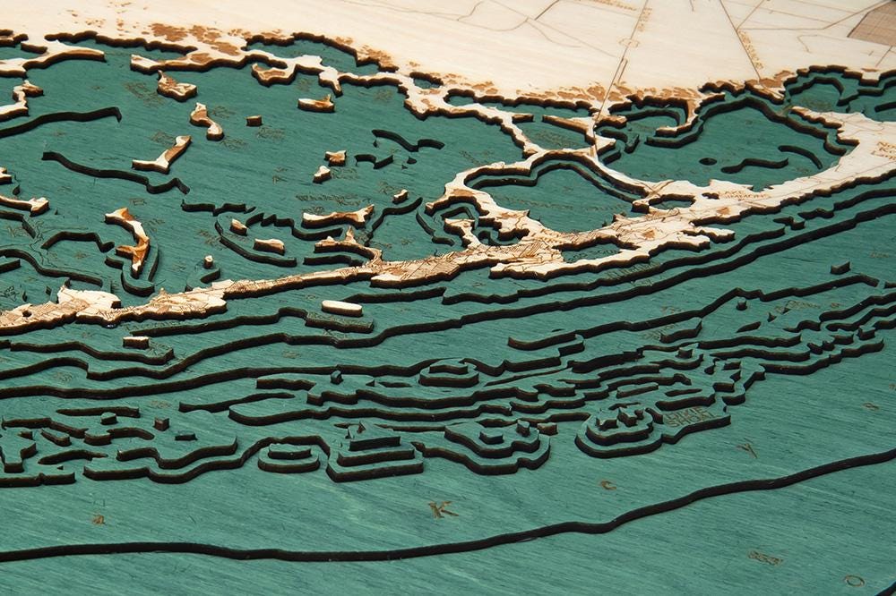 Upper Florida Keys 3D layered wood map in laser-cut Baltic birch, shown framed against a light wall