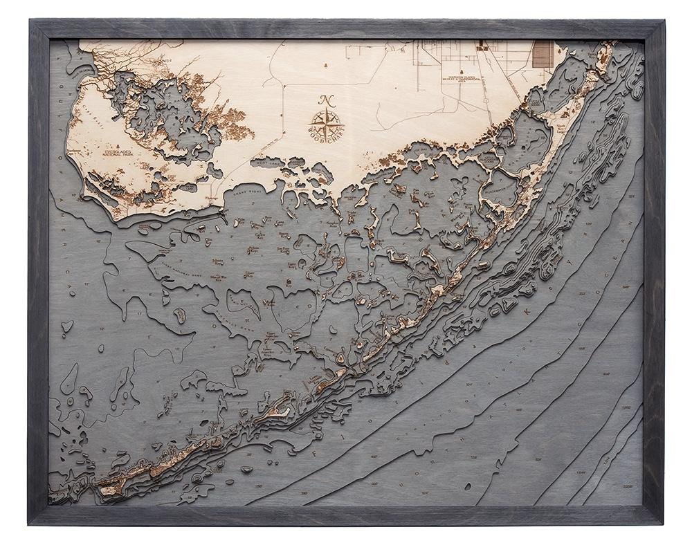 Upper Florida Keys 3D layered wood map in laser-cut Baltic birch, shown framed against a light wall