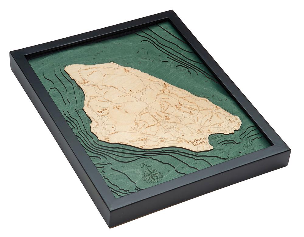 Mackinac Island, Michigan 3D layered wood map in laser-cut Baltic birch, shown framed against a light wall